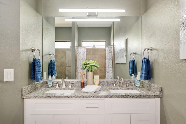 3612 SE 47th Ter, Ocala, FL 34480 - bathroom with a textured wall, a tile shower, and double vanity