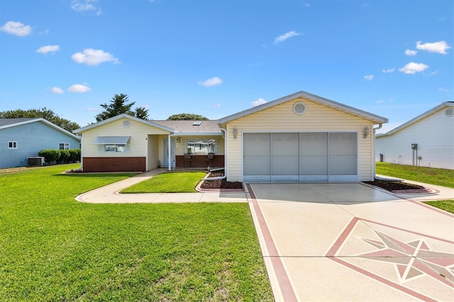 17576 SE 96th Ct, Summerfield, FL 34491 - ranch-style home featuring a front yard, concrete driveway, an attached garage, and cooling unit