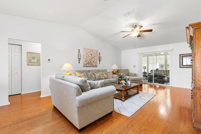 17576 SE 96th Ct, Summerfield, FL 34491 - living room featuring ceiling fan, lofted ceiling, and light wood-style flooring