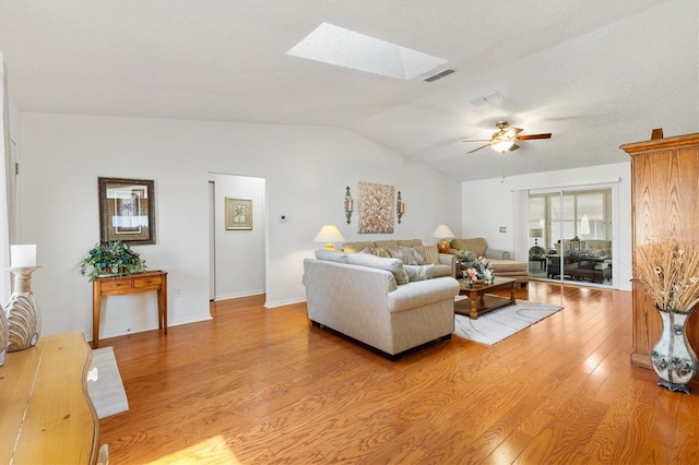 17576 SE 96th Ct, Summerfield, FL 34491 - living area featuring vaulted ceiling, a ceiling fan, light wood-style floors, and a skylight