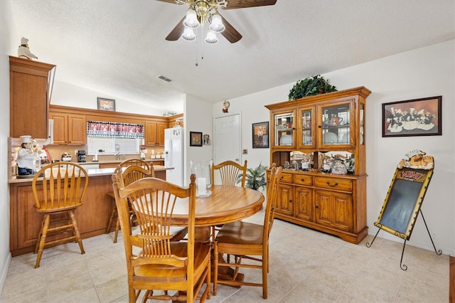 17576 SE 96th Ct, Summerfield, FL 34491 - dining room with a textured ceiling, ceiling fan, lofted ceiling, and light tile patterned floors