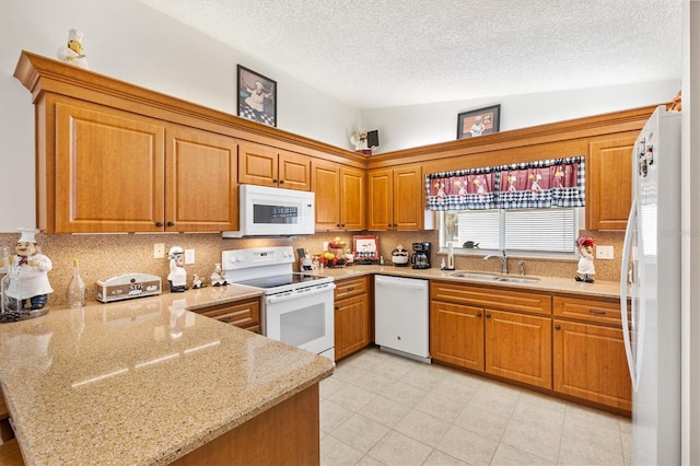 17576 SE 96th Ct, Summerfield, FL 34491 - kitchen with white appliances, a sink, a peninsula, decorative backsplash, and light stone counters