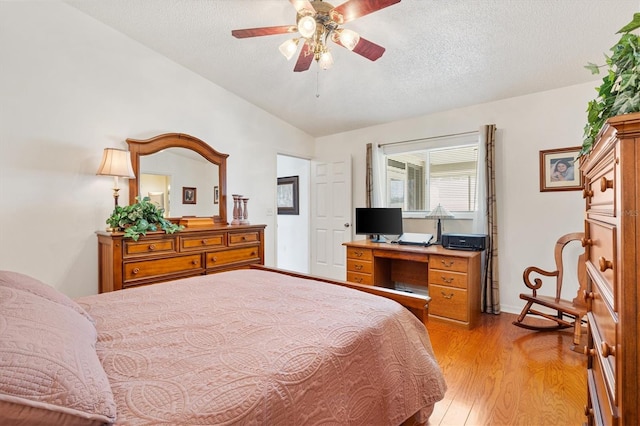17576 SE 96th Ct, Summerfield, FL 34491 - bedroom featuring lofted ceiling, light wood-type flooring, a textured ceiling, and ceiling fan