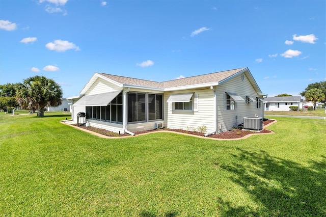 17576 SE 96th Ct, Summerfield, FL 34491 - rear view of house featuring central AC, a sunroom, and a yard
