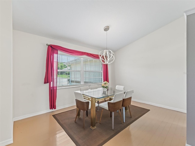 17233 SE 115th Terrace Rd, Summerfield, FL 34491 - dining area with wood finished floors, a chandelier, and baseboards
