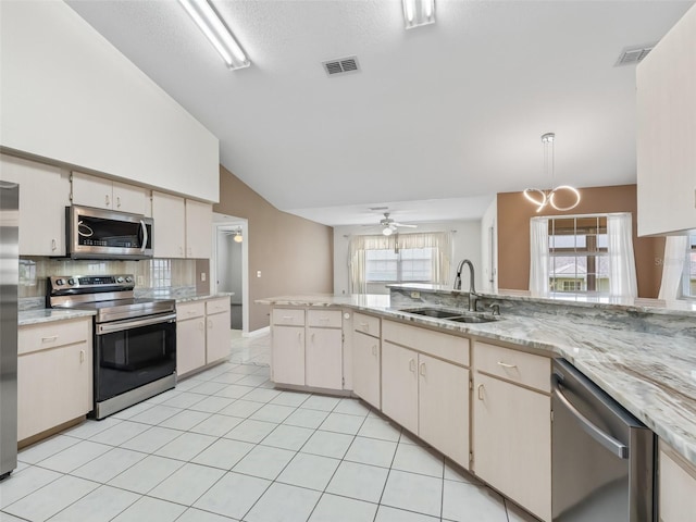 17233 SE 115th Terrace Rd, Summerfield, FL 34491 - kitchen with appliances with stainless steel finishes, a sink, backsplash, a ceiling fan, and vaulted ceiling