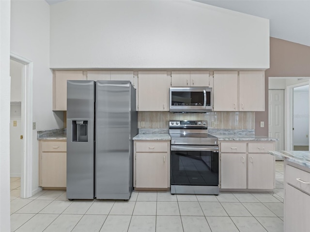 17233 SE 115th Terrace Rd, Summerfield, FL 34491 - kitchen with appliances with stainless steel finishes, light countertops, light tile patterned floors, backsplash, and high vaulted ceiling