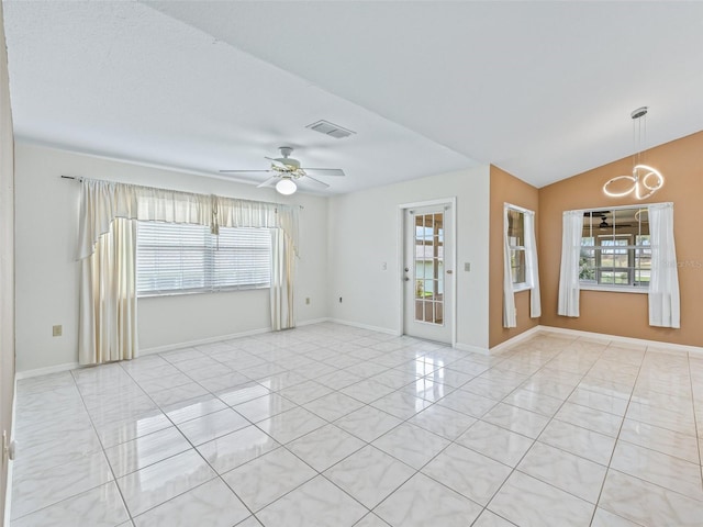 17233 SE 115th Terrace Rd, Summerfield, FL 34491 - unfurnished room featuring plenty of natural light, a ceiling fan, a chandelier, baseboards, and lofted ceiling