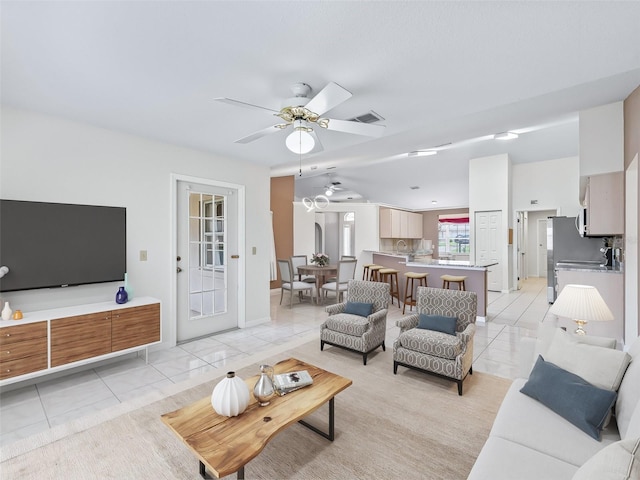 17233 SE 115th Terrace Rd, Summerfield, FL 34491 - living room featuring light tile patterned flooring, a ceiling fan, and baseboards