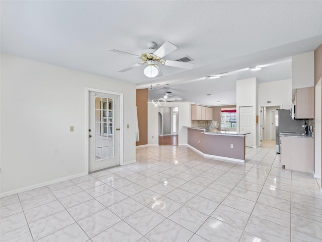 17233 SE 115th Terrace Rd, Summerfield, FL 34491 - unfurnished living room featuring ceiling fan, light tile patterned flooring, and baseboards