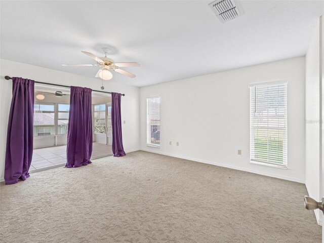 17233 SE 115th Terrace Rd, Summerfield, FL 34491 - spare room with carpet floors, a ceiling fan, and plenty of natural light