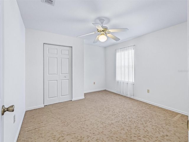 17233 SE 115th Terrace Rd, Summerfield, FL 34491 - unfurnished bedroom featuring carpet, baseboards, a closet, and a ceiling fan