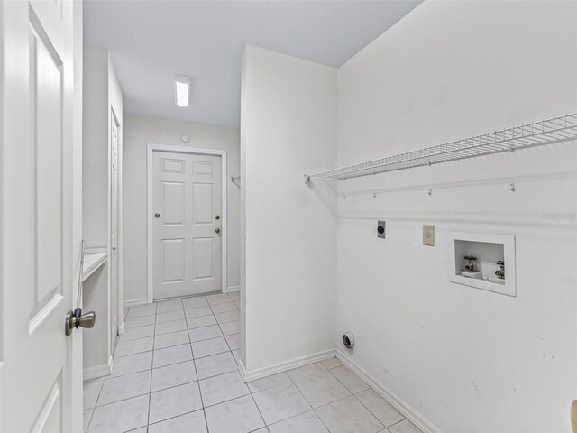 17233 SE 115th Terrace Rd, Summerfield, FL 34491 - washroom featuring electric dryer hookup, washer hookup, light tile patterned floors, and baseboards