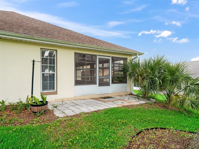 17233 SE 115th Terrace Rd, Summerfield, FL 34491 - back of property featuring roof with shingles, stucco siding, and a lawn