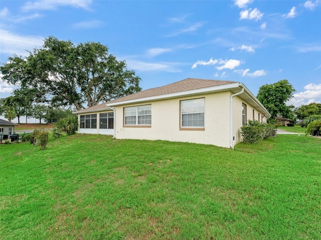 17233 SE 115th Terrace Rd, Summerfield, FL 34491 - rear view of house featuring a lawn and stucco siding
