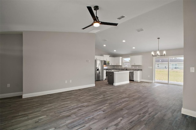 20 Emerald Trl, Ocala, FL 34472 - kitchen with stainless steel appliances, open floor plan, a kitchen island, a chandelier, and white cabinets