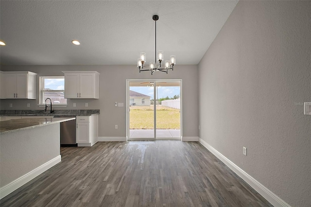 20 Emerald Trl, Ocala, FL 34472 - kitchen featuring dark wood finished floors, white cabinetry, a chandelier, baseboards, and plenty of natural light