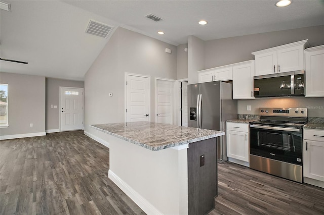 20 Emerald Trl, Ocala, FL 34472 - kitchen with stainless steel appliances, a center island, dark wood-type flooring, white cabinets, and light stone countertops