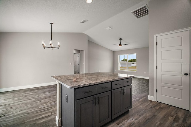 20 Emerald Trl, Ocala, FL 34472 - kitchen with dark wood-style flooring, vaulted ceiling, a chandelier, baseboards, and a center island