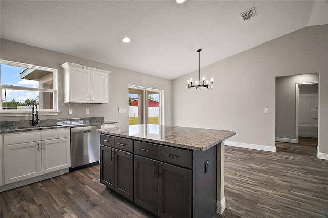 20 Emerald Trl, Ocala, FL 34472 - kitchen featuring stainless steel dishwasher, vaulted ceiling, a sink, dark wood finished floors, and white cabinetry