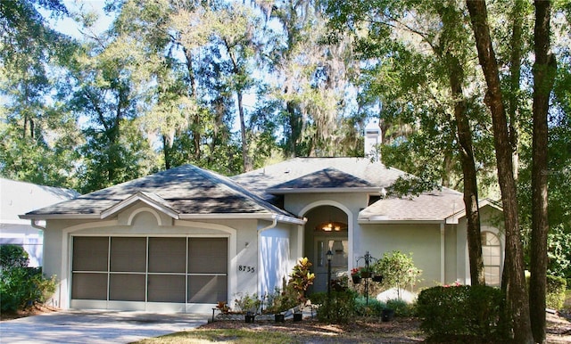 8735 SW 192nd Court Rd, Dunnellon, FL 34432 - ranch-style house with a garage, stucco siding, driveway, a chimney, and roof with shingles