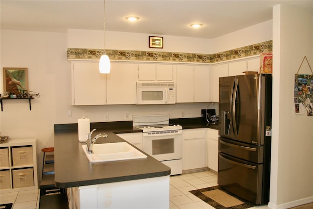 8735 SW 192nd Court Rd, Dunnellon, FL 34432 - kitchen with white appliances, dark countertops, a sink, white cabinets, and recessed lighting