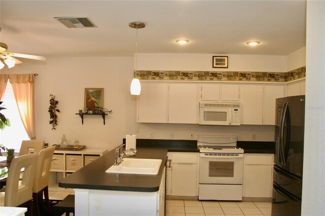 8735 SW 192nd Court Rd, Dunnellon, FL 34432 - kitchen with white appliances, a sink, dark countertops, a ceiling fan, and white cabinetry