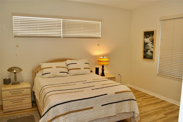 8735 SW 192nd Court Rd, Dunnellon, FL 34432 - bedroom featuring light wood-style floors and baseboards
