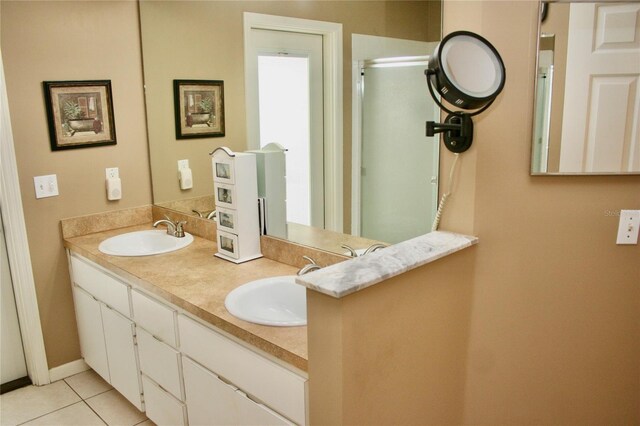 8735 SW 192nd Court Rd, Dunnellon, FL 34432 - bathroom featuring tile patterned floors, double vanity, and a shower with shower door