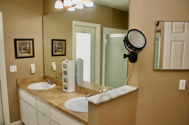 8735 SW 192nd Court Rd, Dunnellon, FL 34432 - full bathroom with double vanity, a shower with door, and a chandelier
