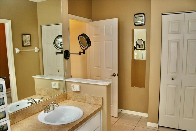 8735 SW 192nd Court Rd, Dunnellon, FL 34432 - bathroom with tile patterned floors, a closet, baseboards, and vanity