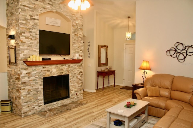 8735 SW 192nd Court Rd, Dunnellon, FL 34432 - living room with wood finished floors, a fireplace, ceiling fan, and a high ceiling