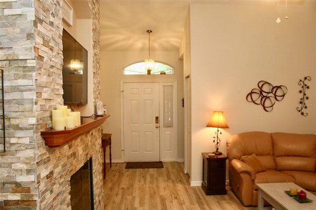 8735 SW 192nd Court Rd, Dunnellon, FL 34432 - foyer entrance featuring light wood-style floors, a fireplace, and baseboards