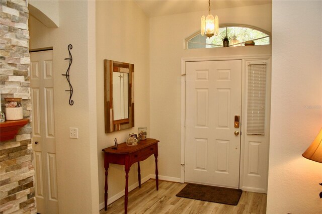 8735 SW 192nd Court Rd, Dunnellon, FL 34432 - entrance foyer featuring light wood-style floors, a chandelier, baseboards, and a high ceiling