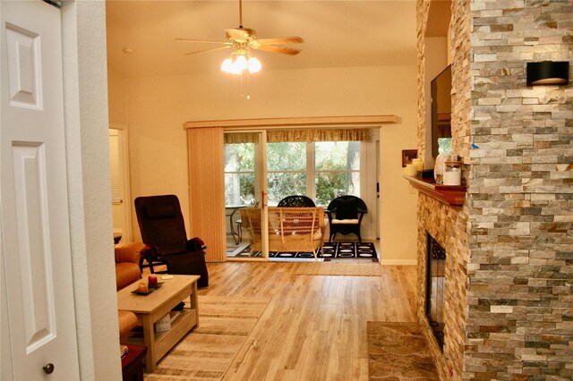 8735 SW 192nd Court Rd, Dunnellon, FL 34432 - living area with wood finished floors, ceiling fan, a stone fireplace, and baseboards