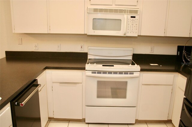 8735 SW 192nd Court Rd, Dunnellon, FL 34432 - kitchen featuring white appliances, dark countertops, and white cabinets