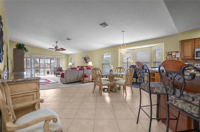 4692 N Lake Vista Trl, Hernando, FL 34442 - dining area with ceiling fan, vaulted ceiling, a textured ceiling, and light tile patterned floors