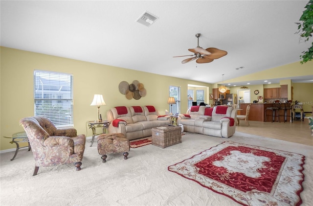 4692 N Lake Vista Trl, Hernando, FL 34442 - living area with vaulted ceiling, a ceiling fan, healthy amount of natural light, light colored carpet, and baseboards