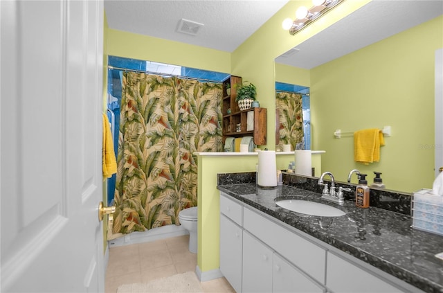 4692 N Lake Vista Trl, Hernando, FL 34442 - bathroom with vanity, toilet, tile patterned floors, baseboards, and a textured ceiling