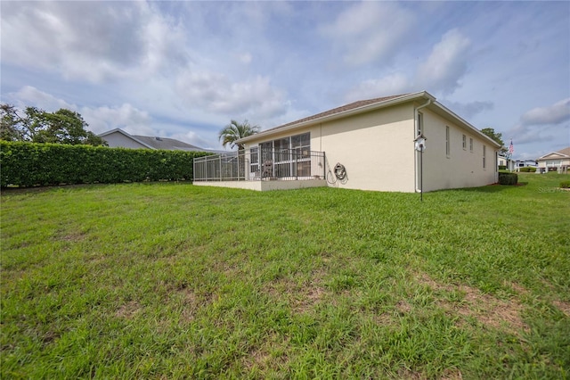 4692 N Lake Vista Trl, Hernando, FL 34442 - rear view of house featuring stucco siding, a yard, and a sunroom