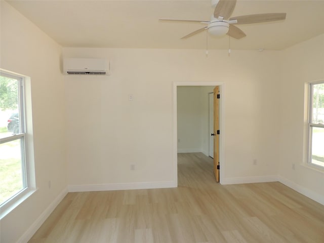 13391 NE 51st St, Williston, FL 32696 - unfurnished room with a wall mounted air conditioner, light wood-style flooring, a ceiling fan, and baseboards