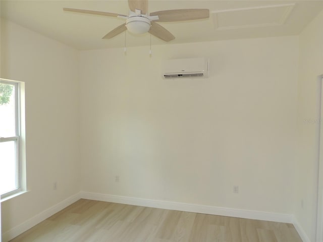 13391 NE 51st St, Williston, FL 32696 - unfurnished room with a wall mounted AC, light wood-style floors, and baseboards