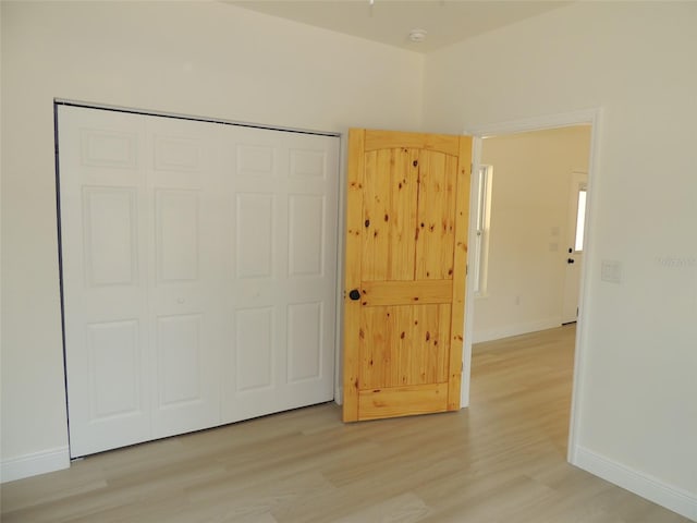 13391 NE 51st St, Williston, FL 32696 - unfurnished bedroom with baseboards, light wood-type flooring, and a closet