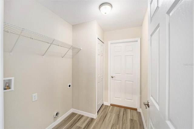 3684 W Fountain Ln, Citrus Springs, FL 34433 - laundry room with light wood-style flooring, electric dryer hookup, baseboards, and hookup for a washing machine