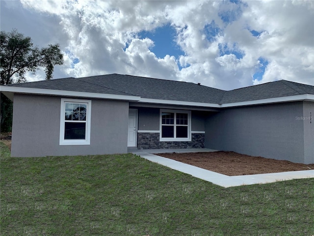 3684 W Fountain Ln, Citrus Springs, FL 34433 - view of front of house with a front yard, stucco siding, stone siding, and a shingled roof