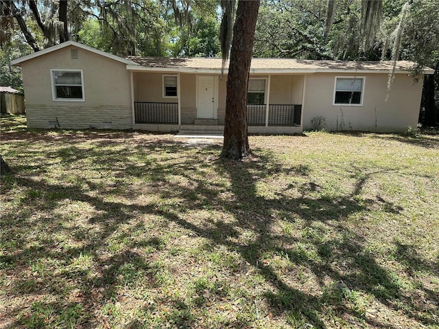 312 NW 28th St, Ocala, FL 34475 - view of front of house with covered porch, a front lawn, stucco siding, and stone siding