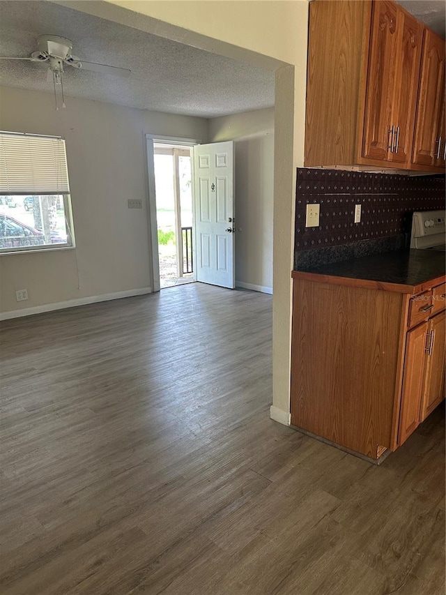 312 NW 28th St, Ocala, FL 34475 - kitchen with open floor plan, dark countertops, dark wood-type flooring, and baseboards