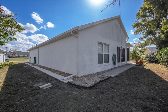 10444 S Clint Loop, Floral City, FL 34436 - view of home's exterior with stucco siding and a yard