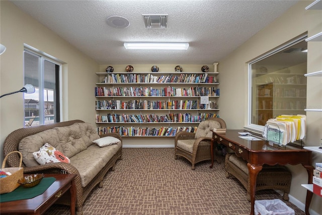 10444 S Clint Loop, Floral City, FL 34436 - sitting room featuring carpet floors and a textured ceiling