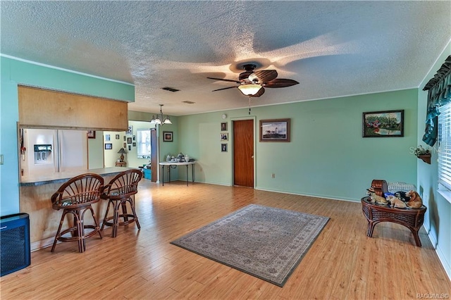 5626 W Justin Ct, Homosassa, FL 34448 - living area with a textured ceiling, wood finished floors, ceiling fan, a chandelier, and baseboards